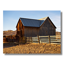 A photo of an barn with a split rail fence in Escalante Utah