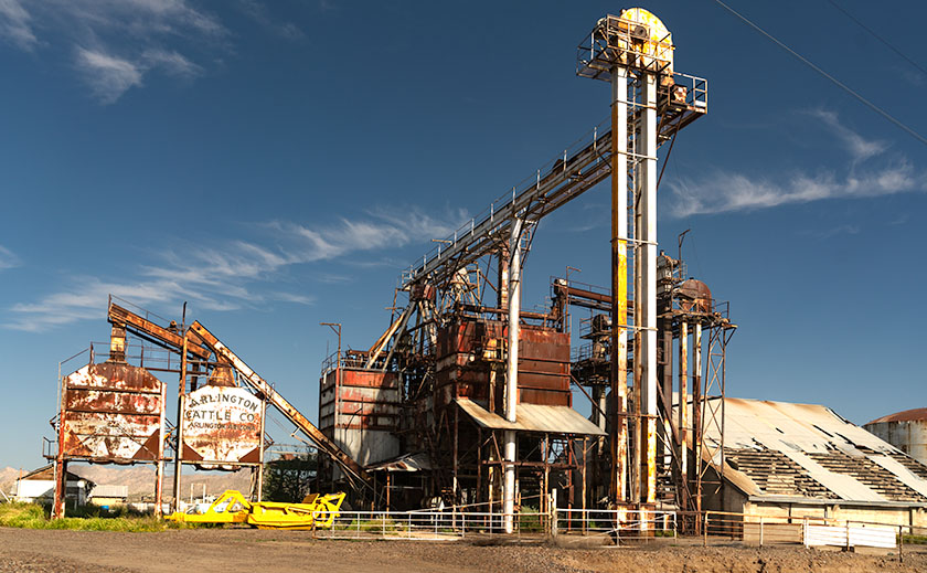 Abandoned Arlington feed mill along old US 80, symbolizing the faded glory of Arizona's cattle industry.