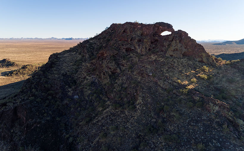 A couple of miles south of Aguila, Arizona is Eagle Eye Peak with its natureal window on top.