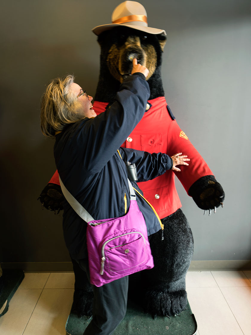 Anne in front of a stuffed bear.