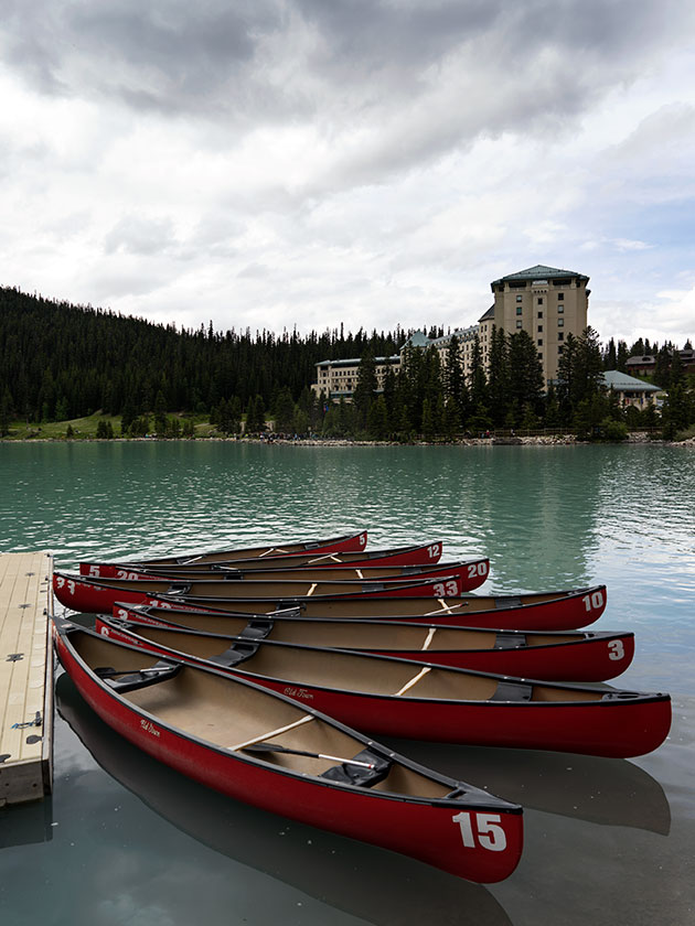 Red canoes in front of hotel.