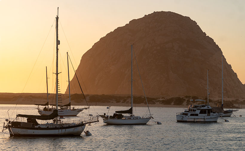 Morro Bay Harbor - private sail boats and cruisers during a calm spring sunset in Morro Bay, California.