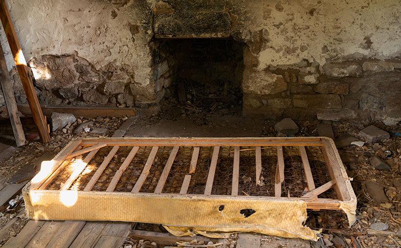 Cozy Bed by the Fire - A discarded box spring left inside the abandoned Richardson House at Union Pass.