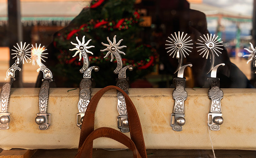 Spurs - Silver spurs on display in the window of a Tombstone boot shop.