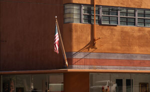 The historic Phelps Dodge Company Store, an Art-Deco gem, with an American flag waving proudly.