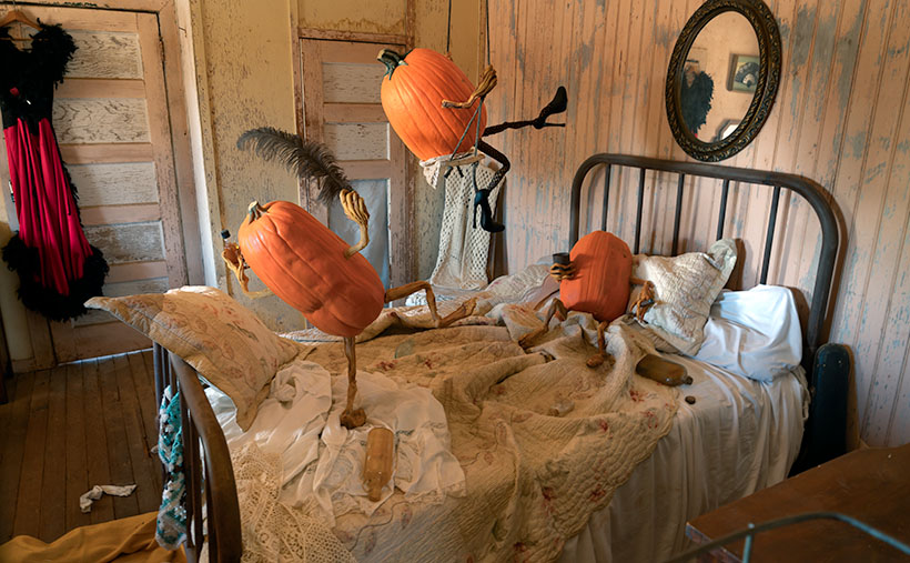 Humorous Halloween scene in Vulture City's brothel with playful pumpkins, hinting at a night of mischief.