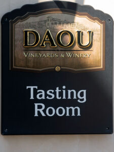 The distinguished sign marking the tasting room at DAOU Vineyards & Winery, inviting visitors to indulge in the art of wine, as photographed by Jim Witkowski.
