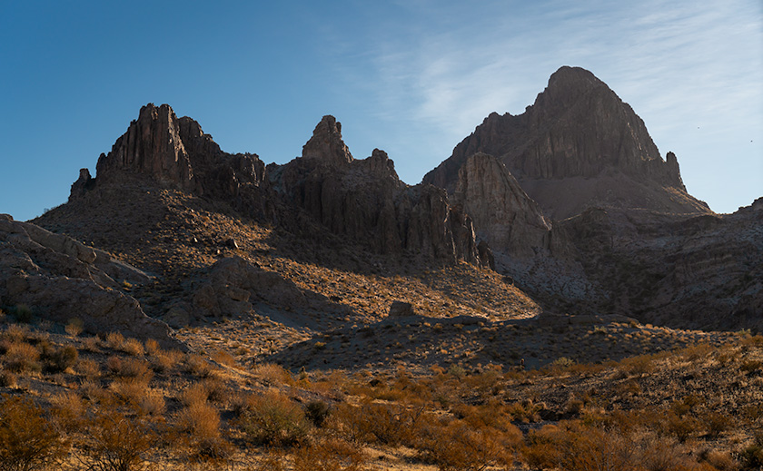 The Boundary Cone, a significant peak for Mohave tribes, stands tall against the morning sky, viewed from the juncture of old Route 66 and Boundary Cone Road.