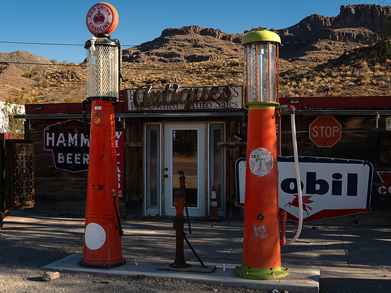 Vintage Red Crown gas pumps in Oatman, Arizona, along the famed Route 66, evoking the golden era of American road travel.