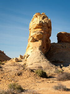 A towering rock formation known as Silica Dome against the clear blue sky in Valley of Fire State Park.