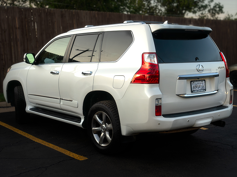 White family SUV parked in motel lot, captured during travel stop