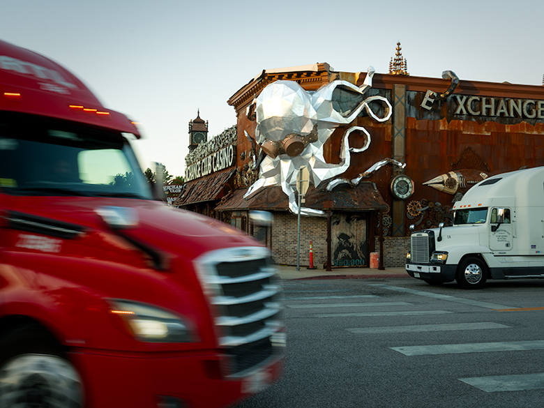 Trucks making sharp turn by closed Exchange Club Casino in Beatty, Nevada Large trucks perform a careful dance around a sharp corner in Beatty, Nevada, by the closed Exchange Casino.