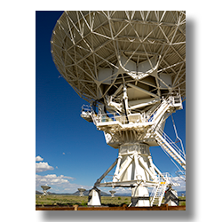 A large radio telescope on the grounds of the VLA