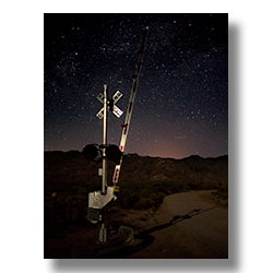 A railroad crossing spends a quiet night guarding the tracks in Piedmont, Arizona