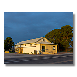 The Palo Verde Post Office glows in the predawn light under dark storm clouds. Photo by Jim Witkowski.