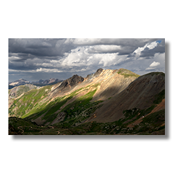 Late afternoon sun shining on the peak of Tuttle Mountain, overlooking Poughkeepsie Gulch in Colorado.