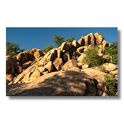 A golden stairway of rock formations ascending to a blue sky in the Granite Dells during sunset.