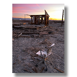 A discarded office chair found at Bombay Beach California at dawn.