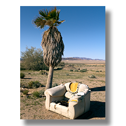 An easy chair discarded behind an abandoned gas staton near Rice California.