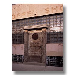 The art deco front door of a closed coffee shop in Silver City New Mexico.
