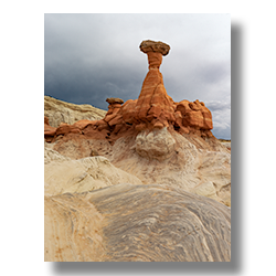 A capstone is held up by a column of red sandstone near Kanab Utah.